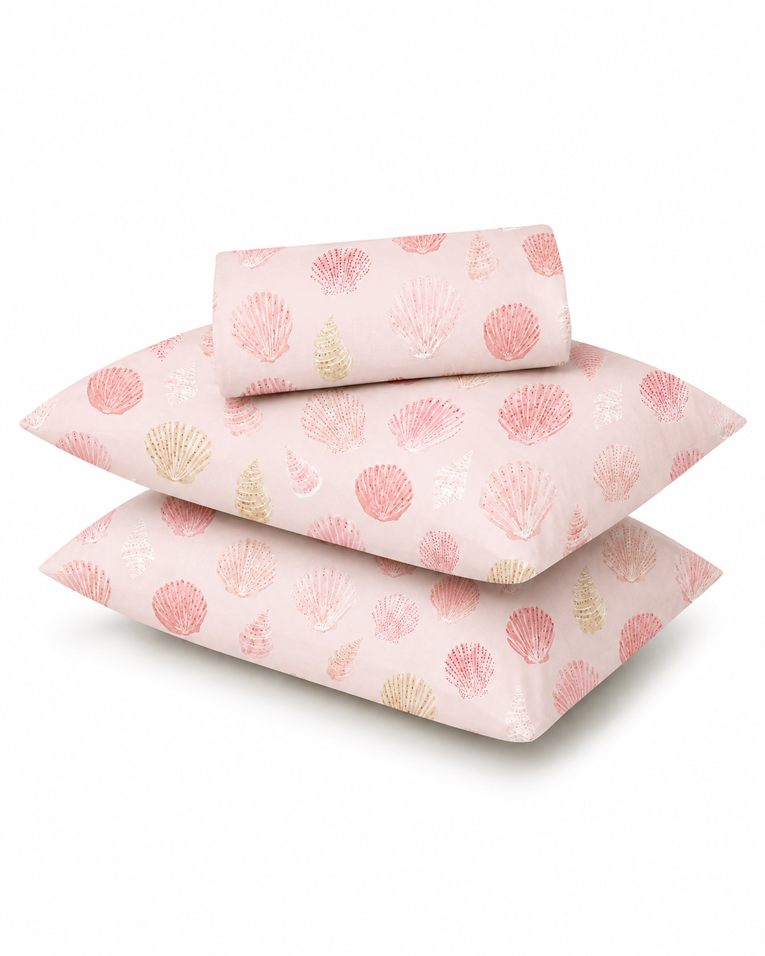Three light pink pillows with a seashell pattern, including one folded sheet or pillowcase, displayed on a clean white background.