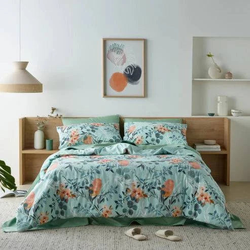 Bedroom featuring a luxurious water-resistant quilt cover set with a native Australian floral print in green and orange tones. 