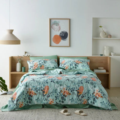 Bedroom featuring a luxurious water-resistant quilt cover set with a native Australian floral print in green and orange tones. 