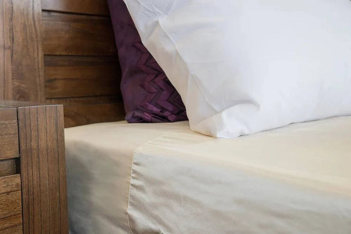 Neeki Designs Wonder Sheet Cream Manchester bedding set featuring soft, luxurious cream-colored fabric with detailed stitching.