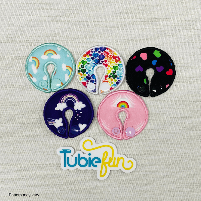 Set of five Tubie Fun regular G-tube button pads featuring colorful rainbows and hearts for nutrition feeding accessories.