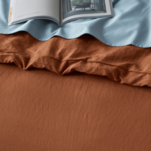 Rust-colored Staydry Linen Look water-resistant quilt cover set in Manchester style, featuring a stylish linen texture and durable fabric.