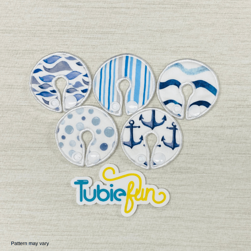 Five Tubie Fun regular G-tube button pads in a sea design, showcasing vibrant colors and soft fabric texture.