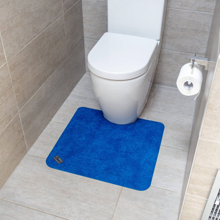 Conni Royal Blue Manchester toilet floor mat with non-slip backing, plush fabric, and decorative border for bathroom comfort.