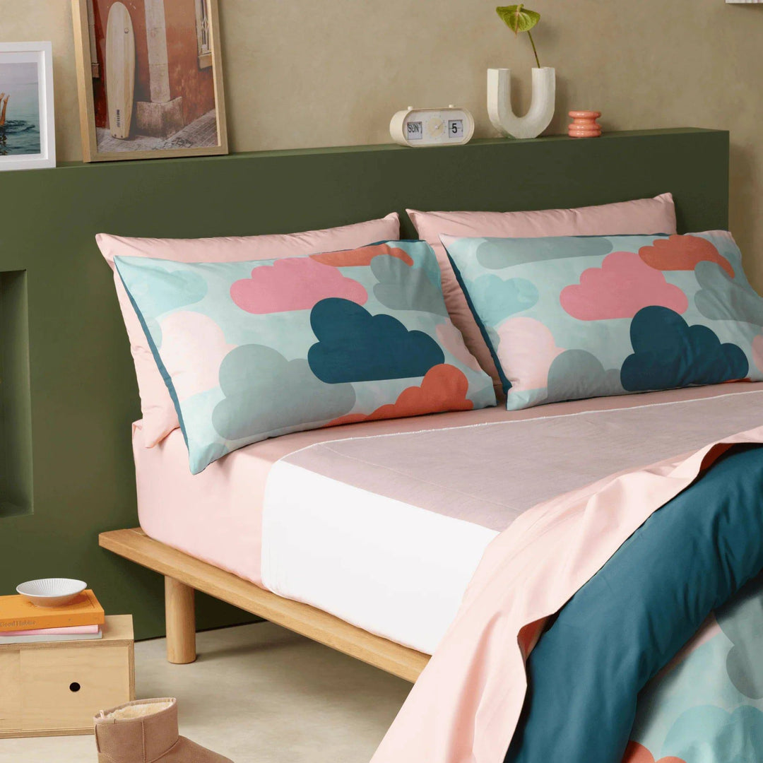 Luxury incontinence friendly bedding set with waterproof sheets in soft blush and deep teal. Featuring a modern cloud-print pillowcase design, stylish and ultra-absorbent bed set offers superior comfort, durability, and discreet protection for uninterrupted sleep. Ideal for those seeking breathable, hypoallergenic, and machine-washable bed linens for incontinence care.