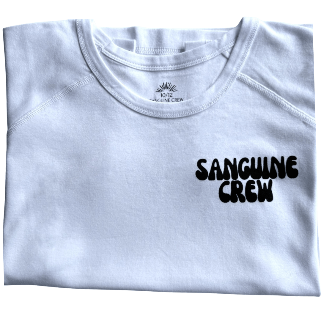 White folded Sanguine Crew T-shirt for kids, showcasing soft fabric and a classic crew neck design.