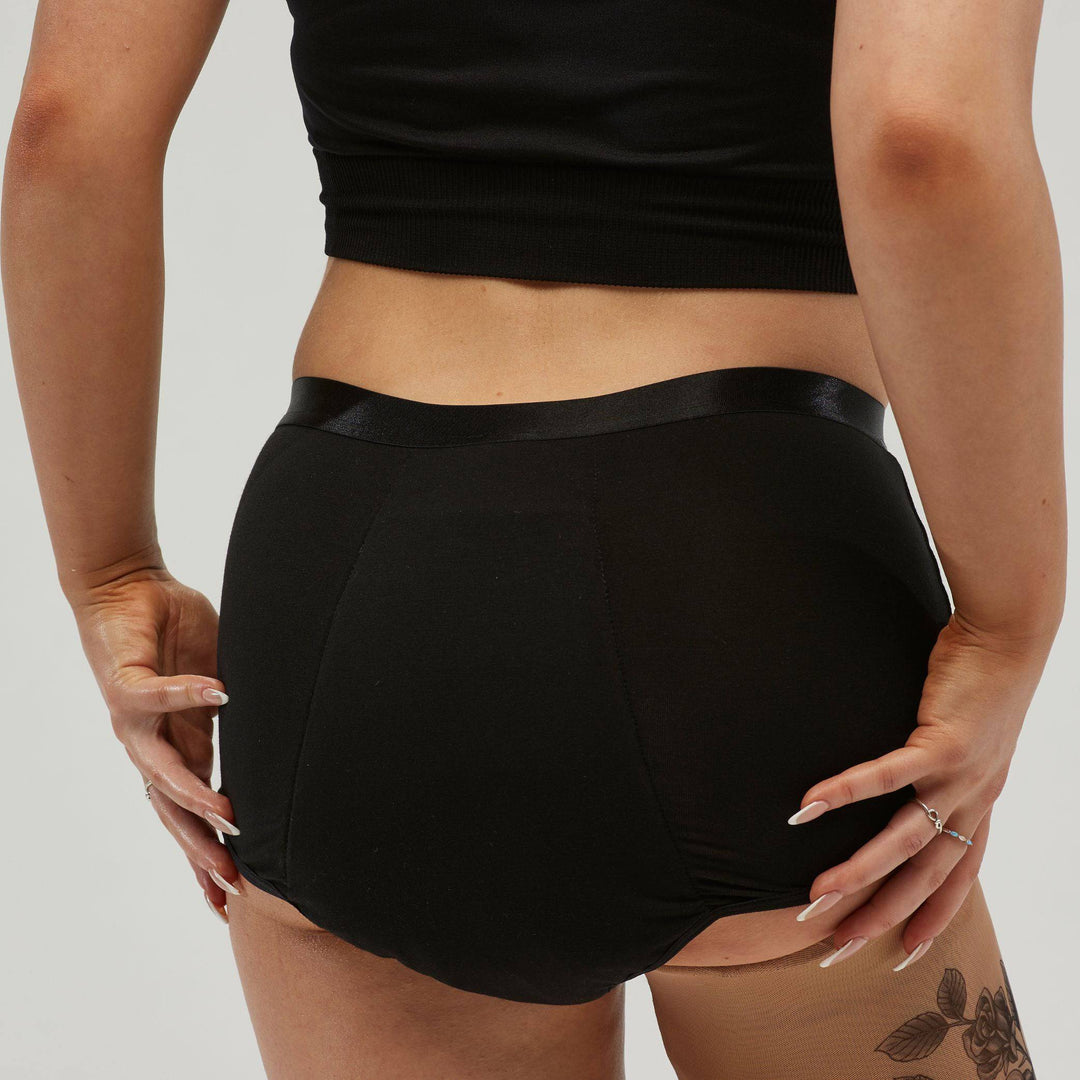 Black Staydry women's full brief for continence, showing the back view with smooth fabric and comfortable fit.