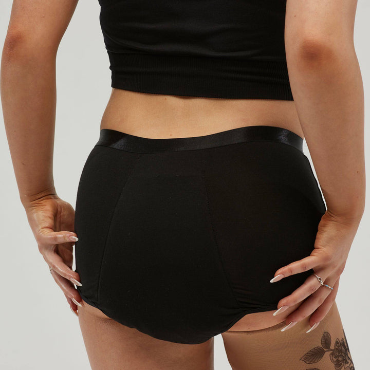 Black Staydry women's full brief for continence, showing the back view with smooth fabric and comfortable fit.