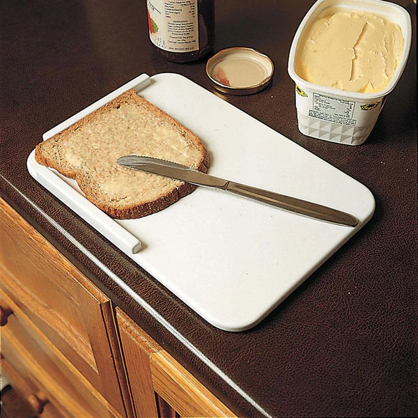 Homecraft Plastic Spread Board by Instacare Shop, featuring a durable, lightweight design for easy food preparation.