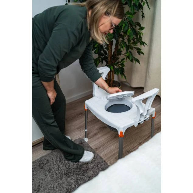 White King Commode by Performance Health with armrests and an open hole, designed for mobility support.