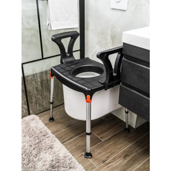 Performance Health black king commode over toilet with armrests for mobility assistance and comfort.