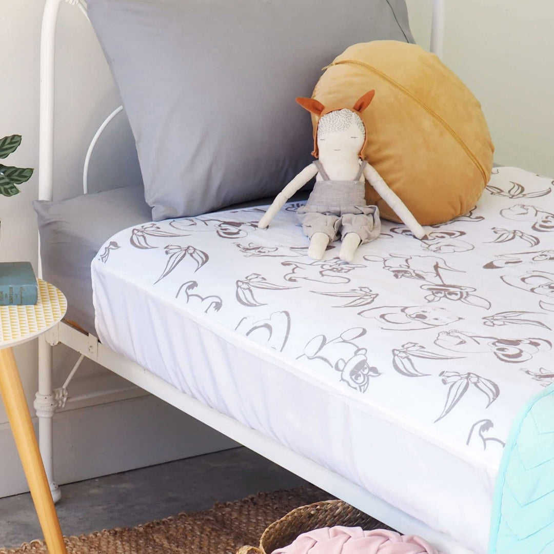 Conni Kids Bed Pad with Tuck-ins featuring Aussie Animals design, soft fabric, and secure tuck-in edges for comfort.