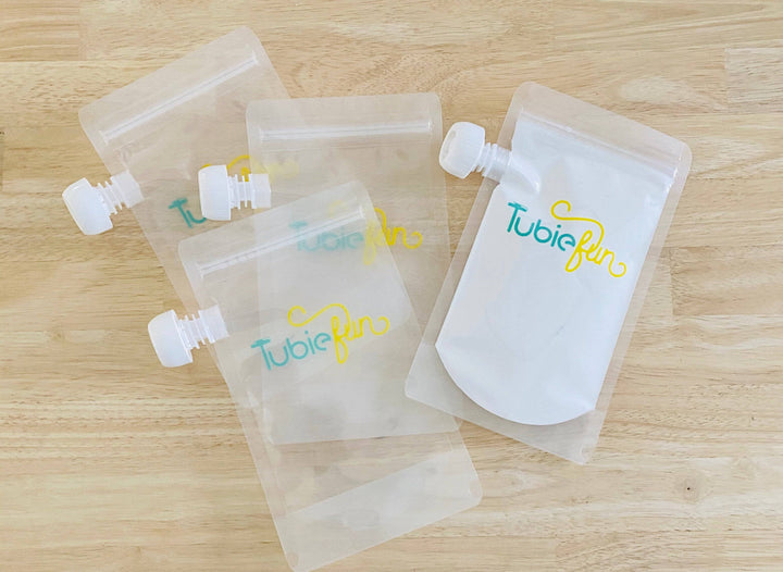 Reusable Tubie Fun 500ml nutrition pouches with colorful leak-proof design for easy feeding and storage.
