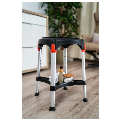 Black King Rotating Round Stool with Tray by Performance Health in a room setting, showcasing its mobility and design.