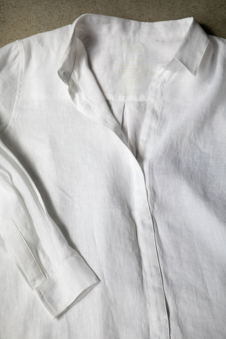 Flat lay of JAM the Label Femme linen shirt, showcasing its relaxed fit and natural fabric texture.