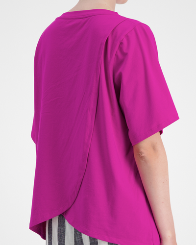 Lilli Leaf Back T-Shirt shown from behind featuring vibrant magenta fabric with unique overlapping leaf-style back design, short sleeves, and StainFree adaptive technology. Close-up view demonstrates the innovative easy-dressing functionality and premium fabric quality.