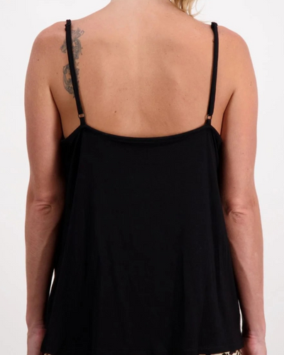 Back view of the Christine Adaptive Camisole in classic black, showing delicate adjustable straps and a flowing silhouette that drapes elegantly across the shoulders. The luxe layering essential features a clean-lined design with subtle details against fair skin.