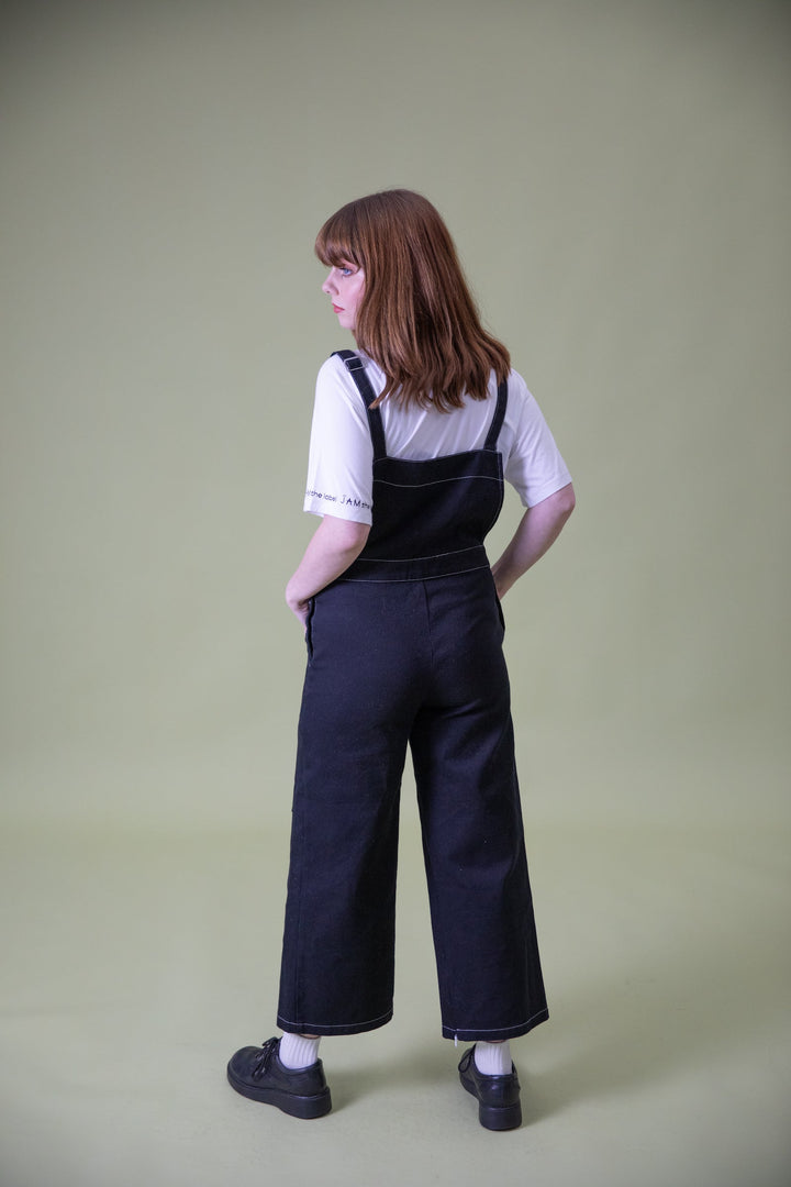 Back view of JAM the Label magnetic buckle overalls, showcasing their relaxed fit and stylish design in natural fabric.