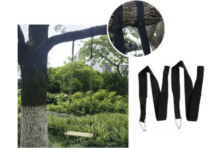 Black tree strap with carabiner, designed for special needs play equipment, secured to a tree in an outdoor setting.