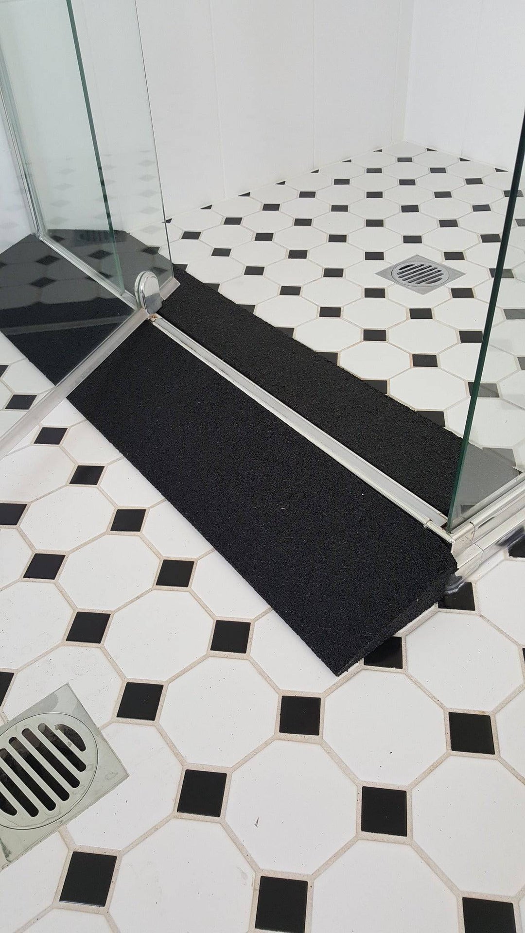 Tyrex recycled rubber shower ramp designed for improved access and mobility assistance in bathrooms.