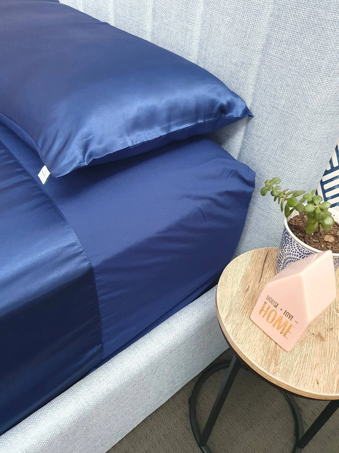 Blue Manchester Wonder Sheet by Neeki Designs, showing the soft, smooth fabric and neatly folded bedding on a bed.