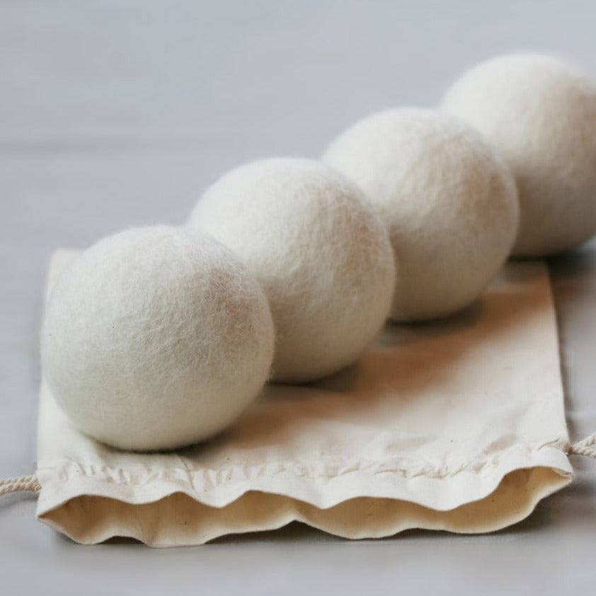 Set of four Brolly NZ Wool Dryer Balls by Brolly Sheets, showing soft felted wool balls for laundry drying.