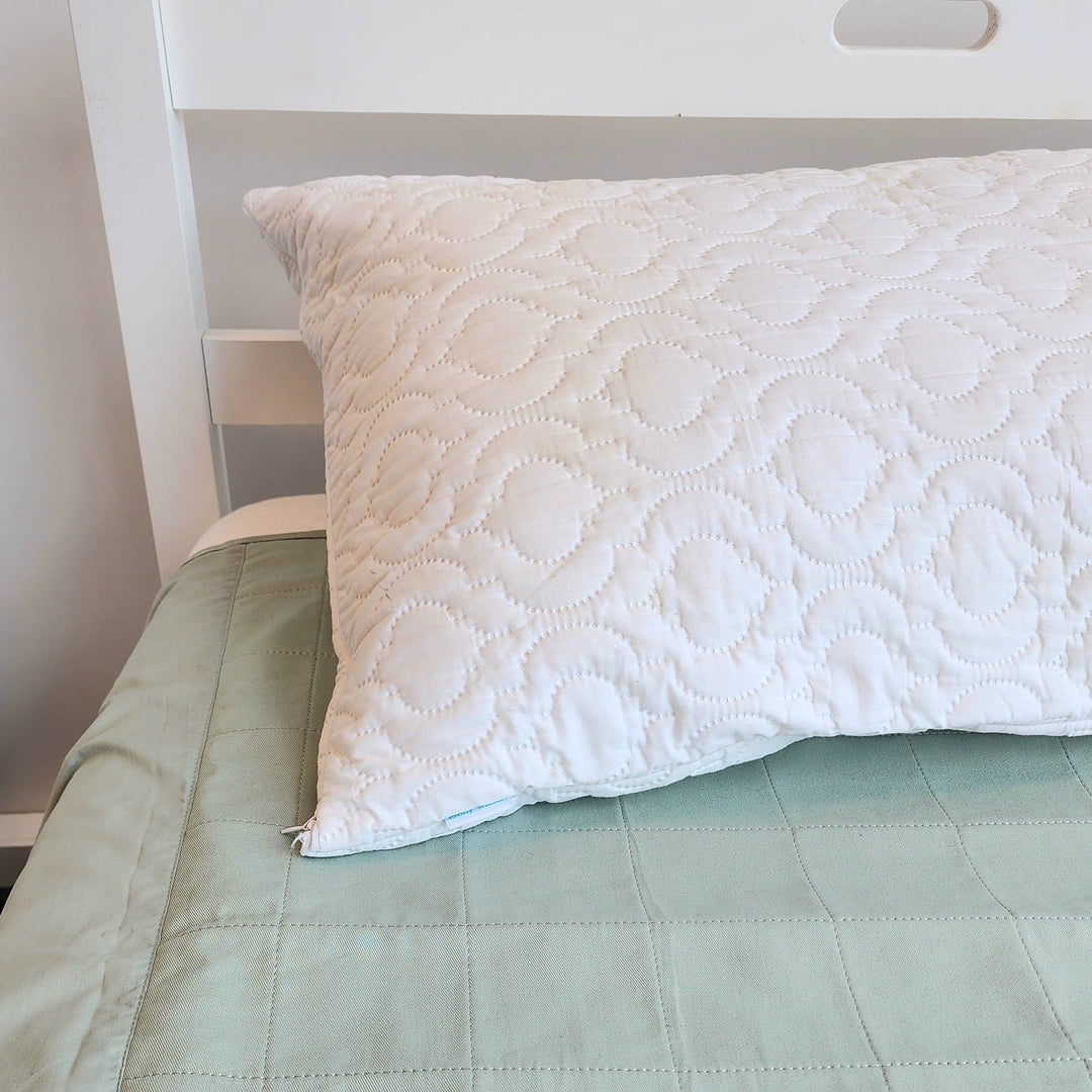 Waterproof quilted Brolly Pillow Protector by Brolly Sheets on a Manchester pillow, showing its protective, padded design.