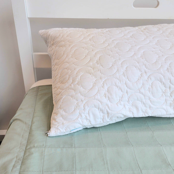 Waterproof quilted Brolly Pillow Protector by Brolly Sheets on a Manchester pillow, showing its protective, padded design.