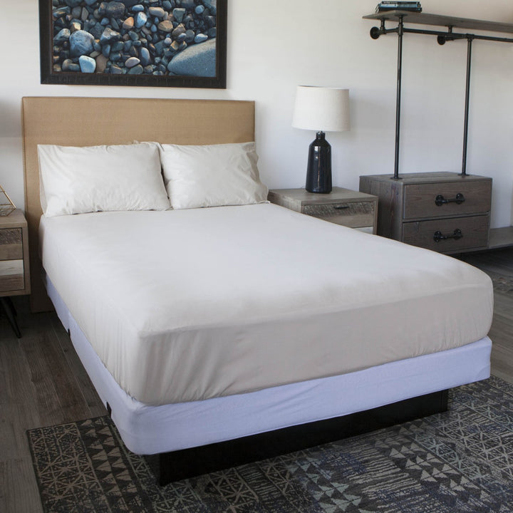 Conni Manchester mattress protector on a double bed, showing its soft fabric and secure fitting for added comfort and protection.