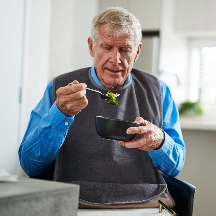 Adult washable tray bib from Brolly Sheets, an adaptive clothing item designed for easy protection and comfort.