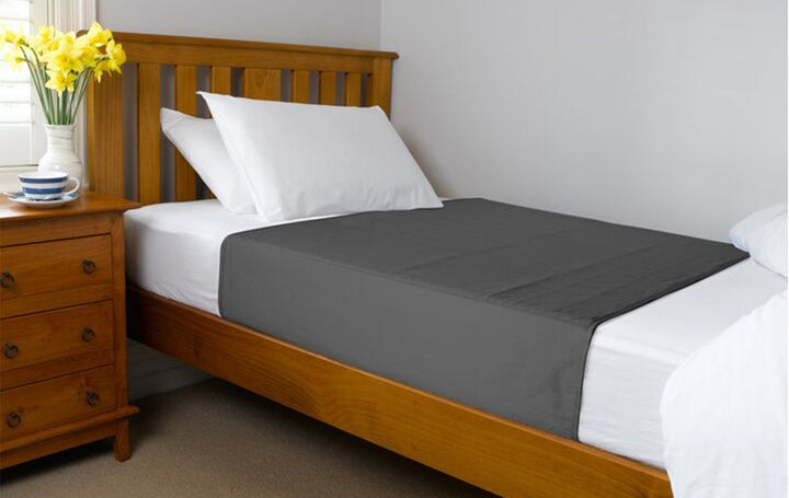 Grey Brolly Sheets bed pad with wings, designed for adults, featuring soft fabric for added comfort and protection.