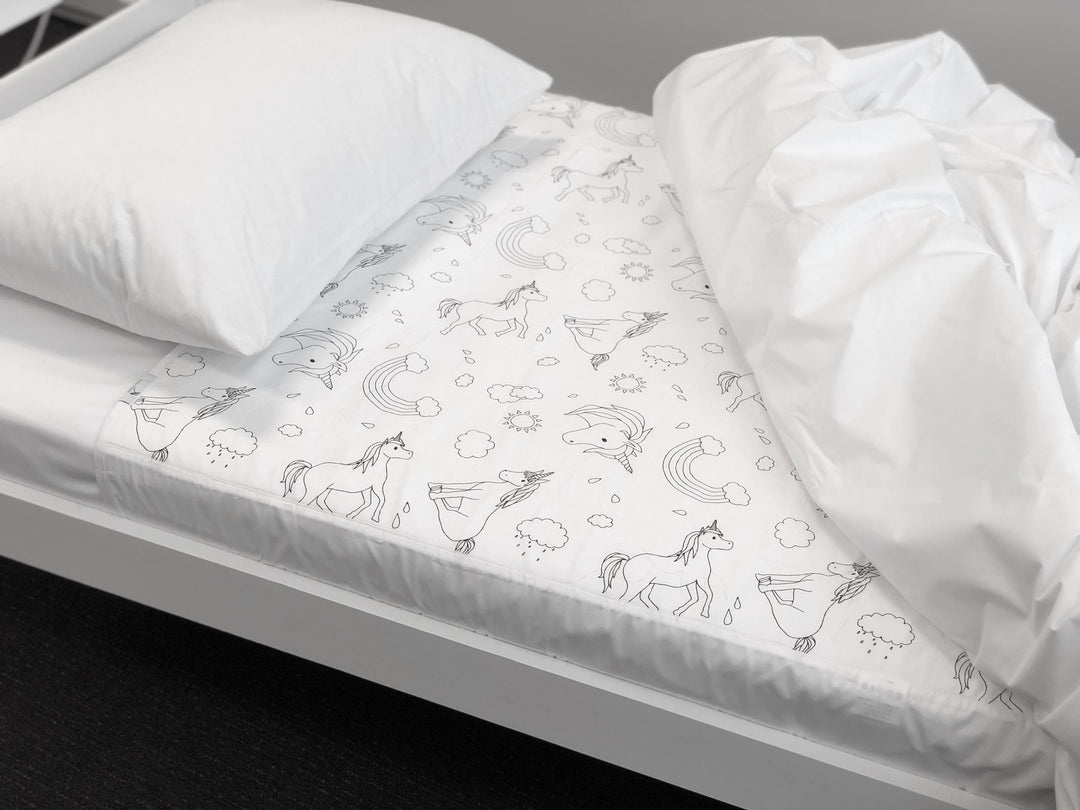 Brolly Sheets bed pad with wings featuring a unicorn design, perfect for protecting mattresses and ensuring comfort.