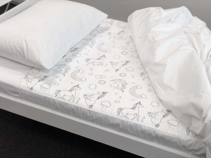 Brolly Sheets bed pad with wings featuring a unicorn design, perfect for protecting mattresses and ensuring comfort.