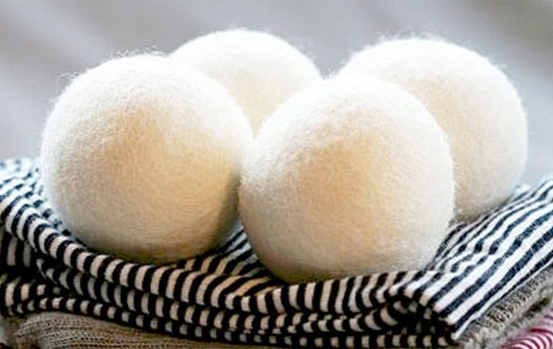 Set of four Brolly NZ Wool Dryer Balls from Brolly Sheets, natural Manchester wool, used for softening laundry in the dryer.