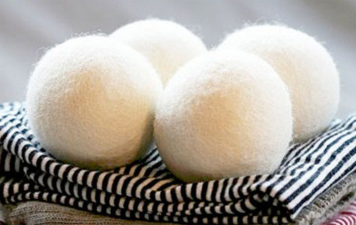 Set of four Brolly NZ Wool Dryer Balls from Brolly Sheets, natural Manchester wool, used for softening laundry in the dryer.