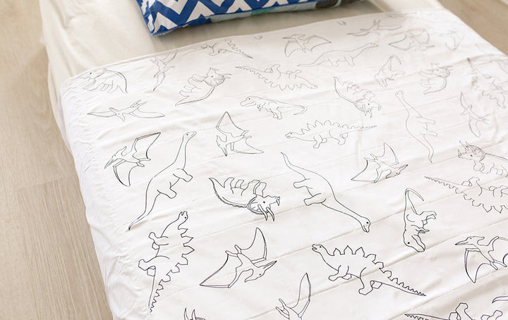 Brolly Sheets bed pad with wings featuring a colorful dinosaur print, designed for single or king single beds.