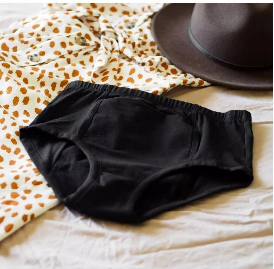 Conni Classic Ladies Black continence pad shown in white with black accents, designed for discreet bladder leak protection.