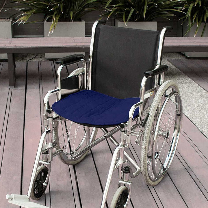 Double-sided waterproof Brolly Chair Pad in navy, designed for wheelchair comfort and protection.
