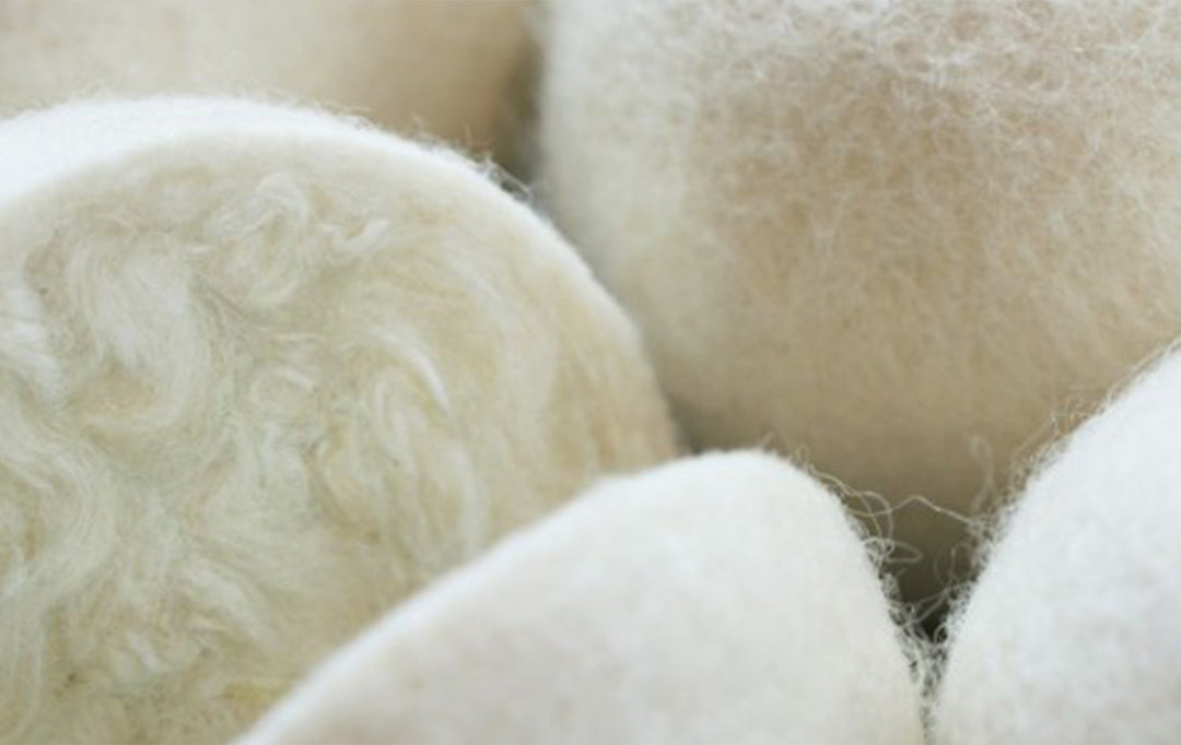 Close-up of Brolly NZ Wool Dryer Balls from Brolly Sheets, four Manchester-style eco-friendly laundry dryer balls.