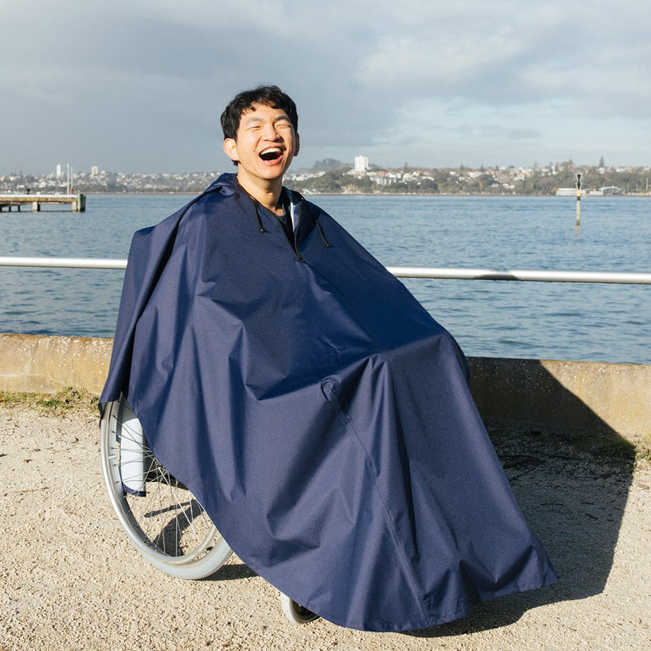 Front view of Brolly Sheets wheelchair rain coat, an adaptive clothing item designed to protect wheelchairs from rain.