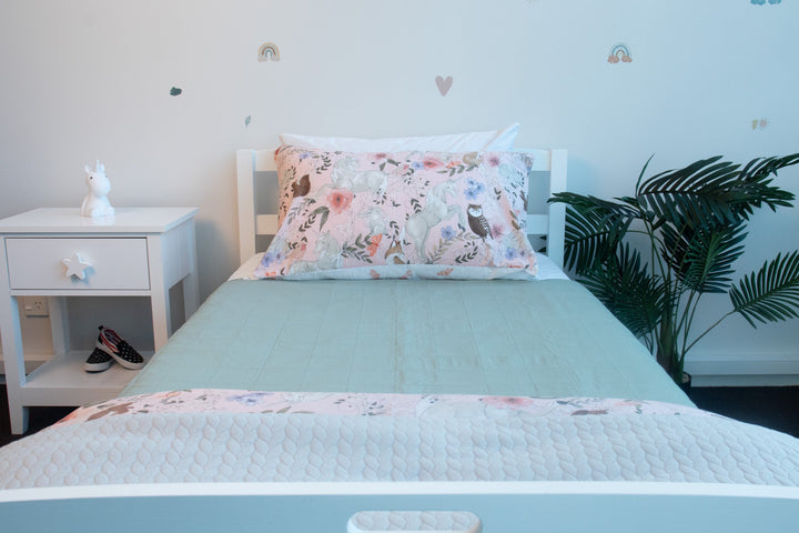 Brolly Sheets bed pad with wings, featuring a soft fabric, designed for mattress protection and comfort.