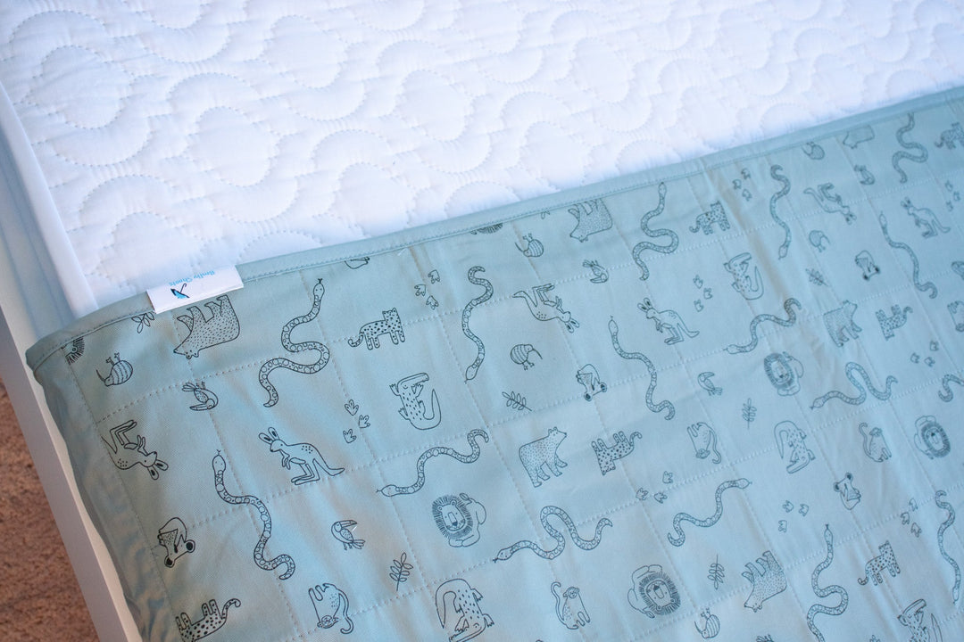 Brolly Sheets bed pad with wings, featuring soft fabric and waterproof backing for mattress protection.