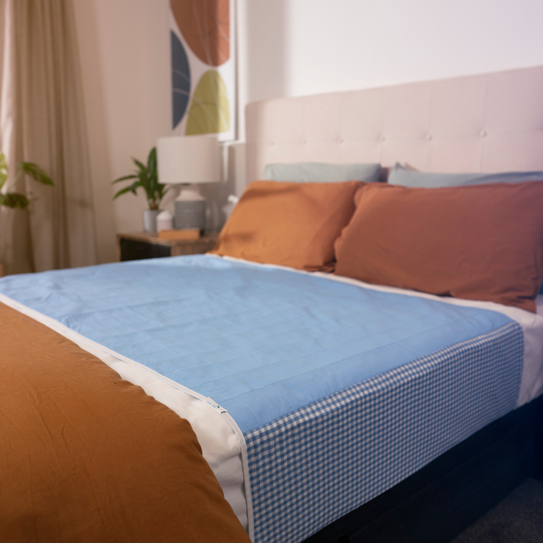 Manchester Brolly Sheet Bed Pad with Wings by Brolly Sheets, showing a soft, absorbent bed protector with side wings for added coverage.