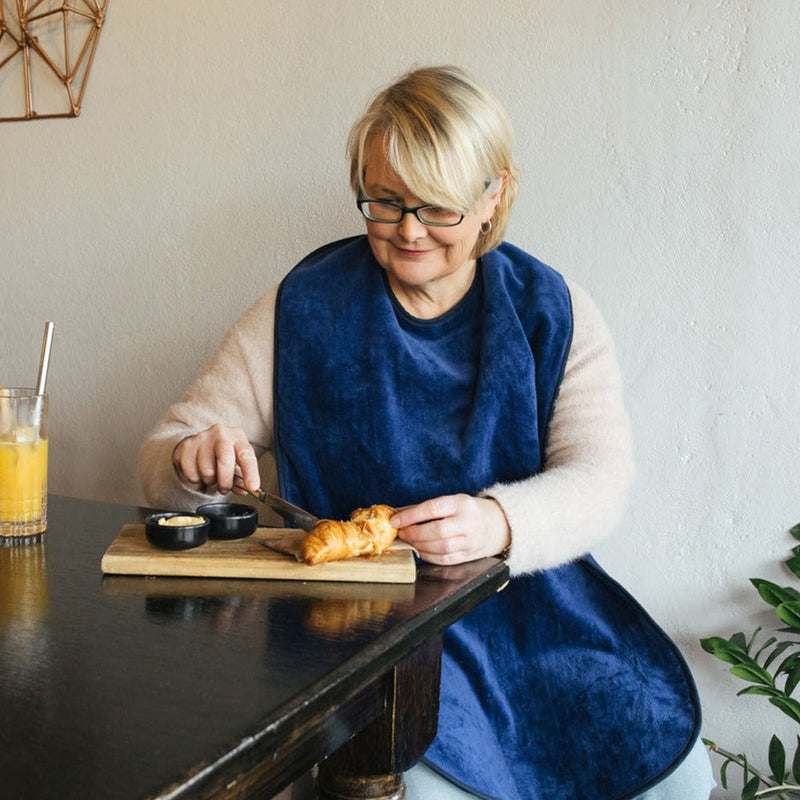 lady with snack wearing blue adults bib extra absorbent