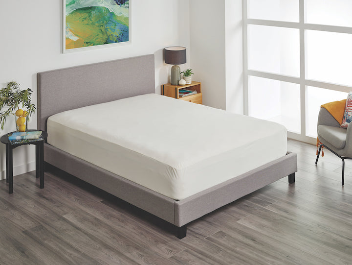 Cream Protect-A-Bed Fusion 2-in-1 fitted sheet and protector by SleepCorp® displayed on a bed.