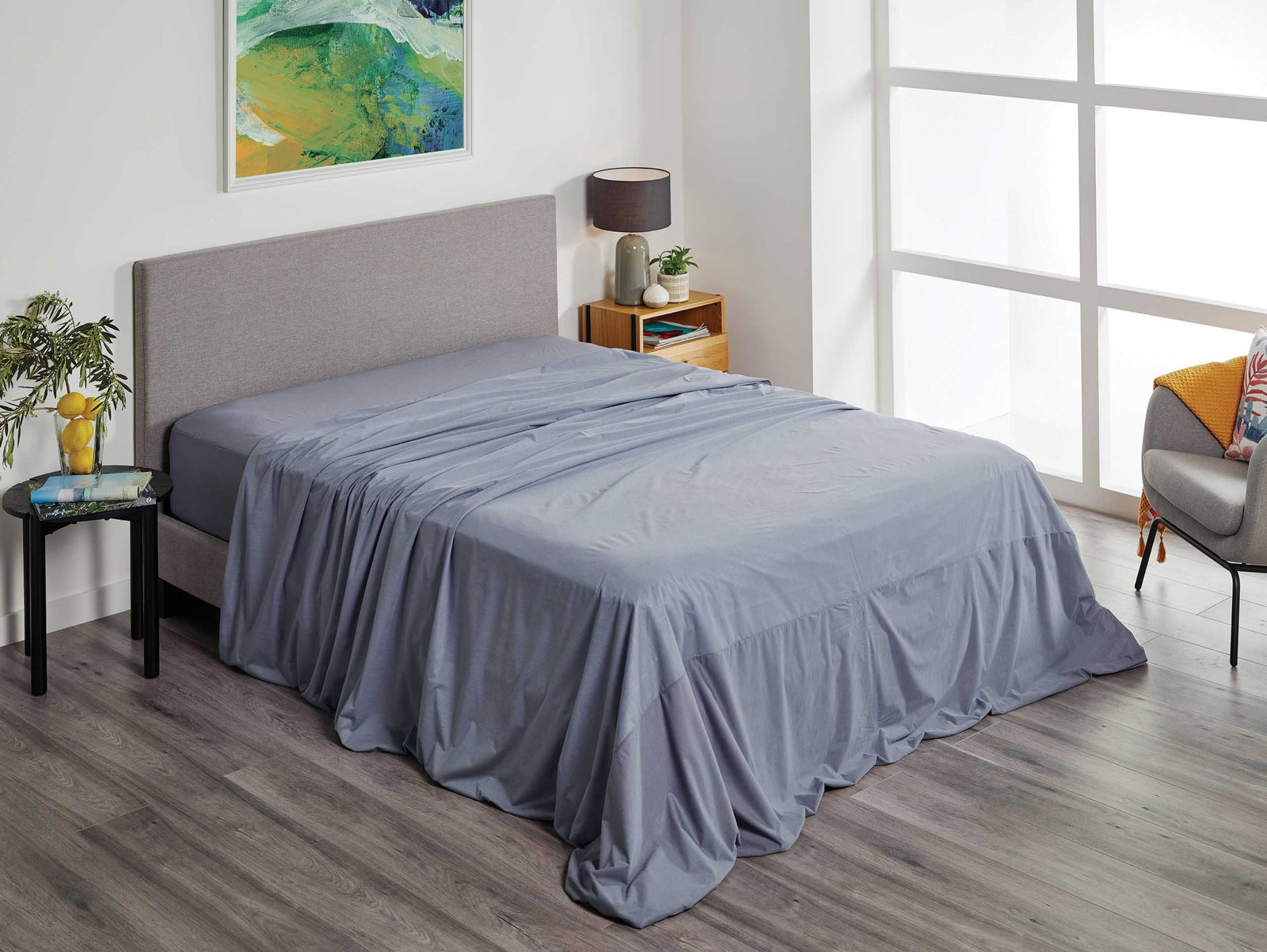 Charcoal Protect-A-Bed® Fusion waterproof flat sheet on a bed, showcasing soft fabric and smooth texture.