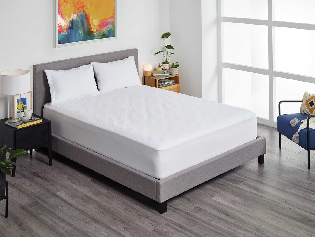 Protect-A-Bed Impression Tencel Jacquard mattress protector on a mattress, showcasing the Manchester style and luxurious jacquard fabric.