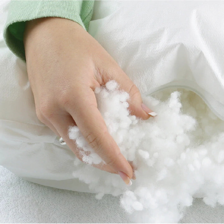 Protect-A-Bed® Staywhite™ Manchester pillow with white pillowcase, showing plush fabric and stitched edges.