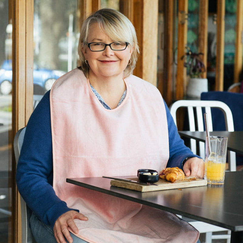 Extra absorbent Pink adults bib on smiling beautiful lady