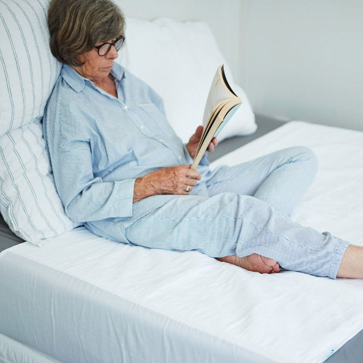 White Brolly Sheets bed pad with wings, washable and waterproof, ideal for added protection on bedding.